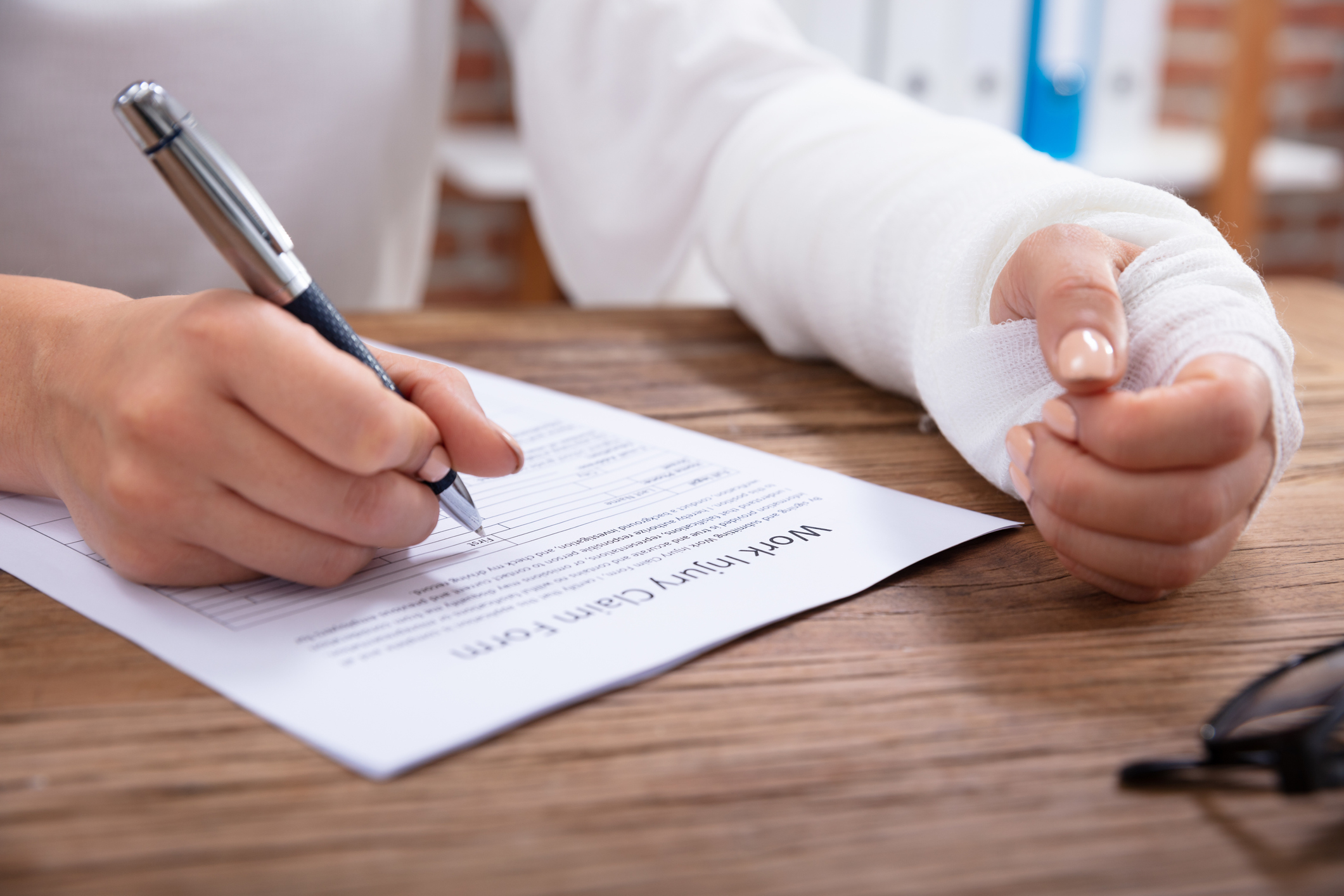person with cast writing