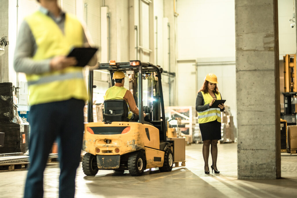 warehouse workers and forklift