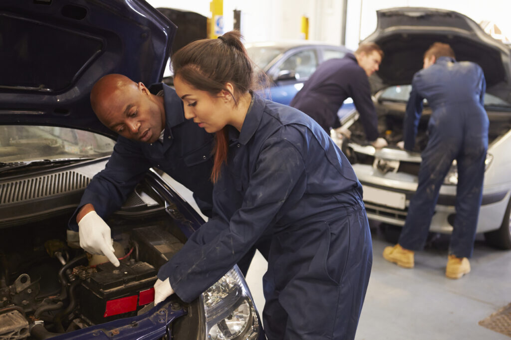 person working on car in class