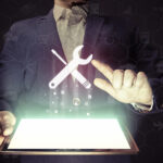 person with tablet and tool icon
