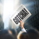 newspaper held up with headline "Gotcha!"