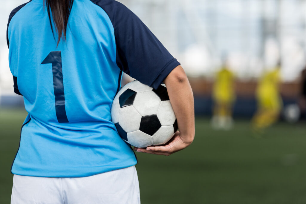 soccer player holding soccer ball