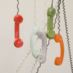 phone handsets hanging by chords