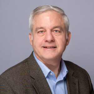 Headshot of a man in a blazer