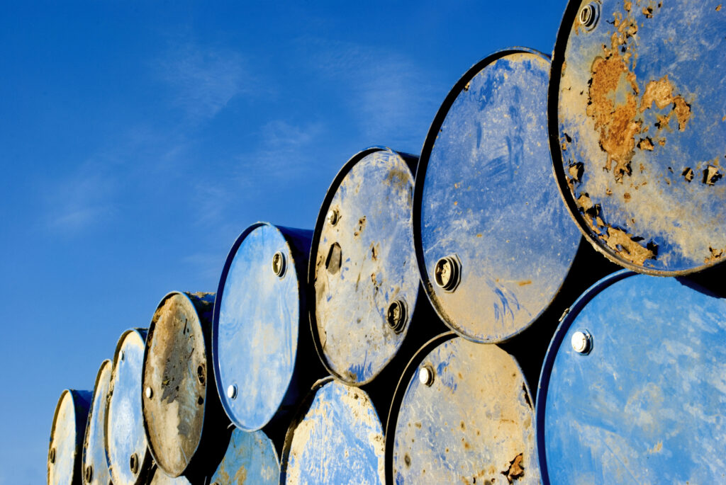 Rusty metal barrels stacked in rows