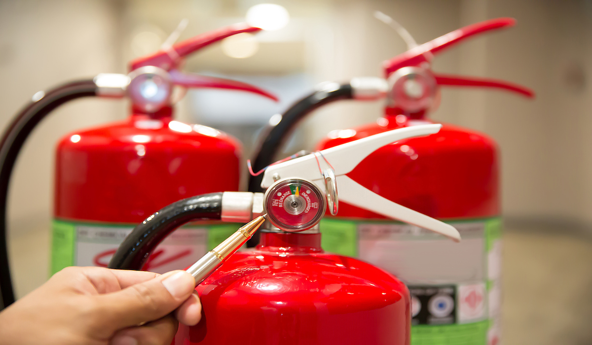 Engineers are checking fire extinguishers.