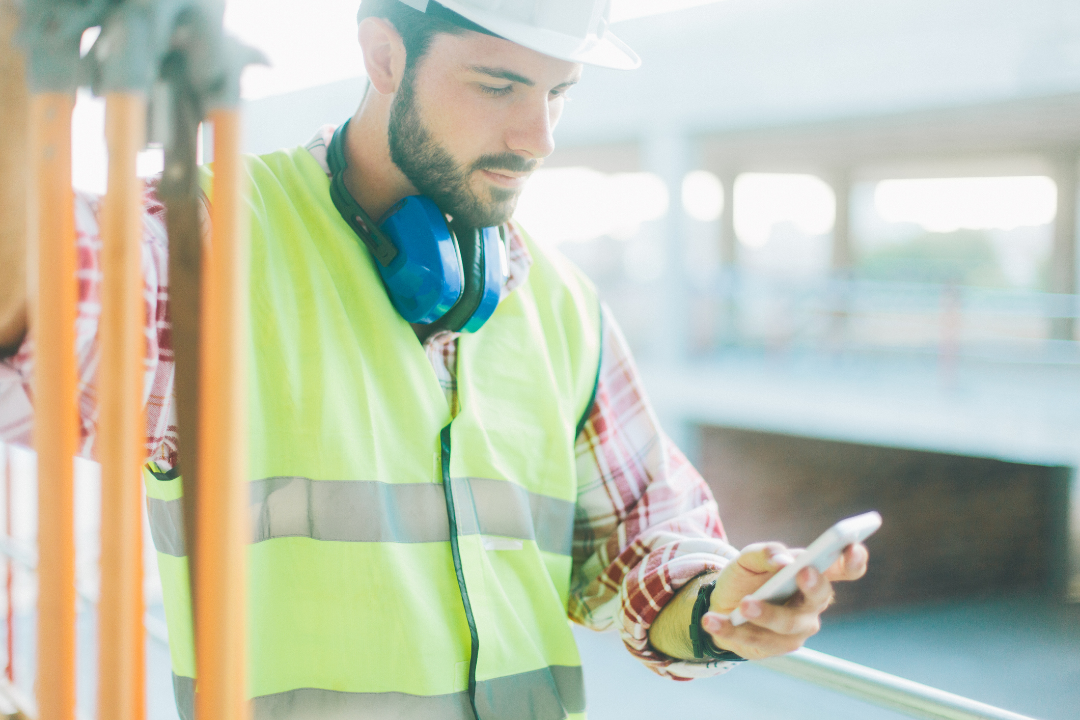 Land surveyor using app on smart phone.